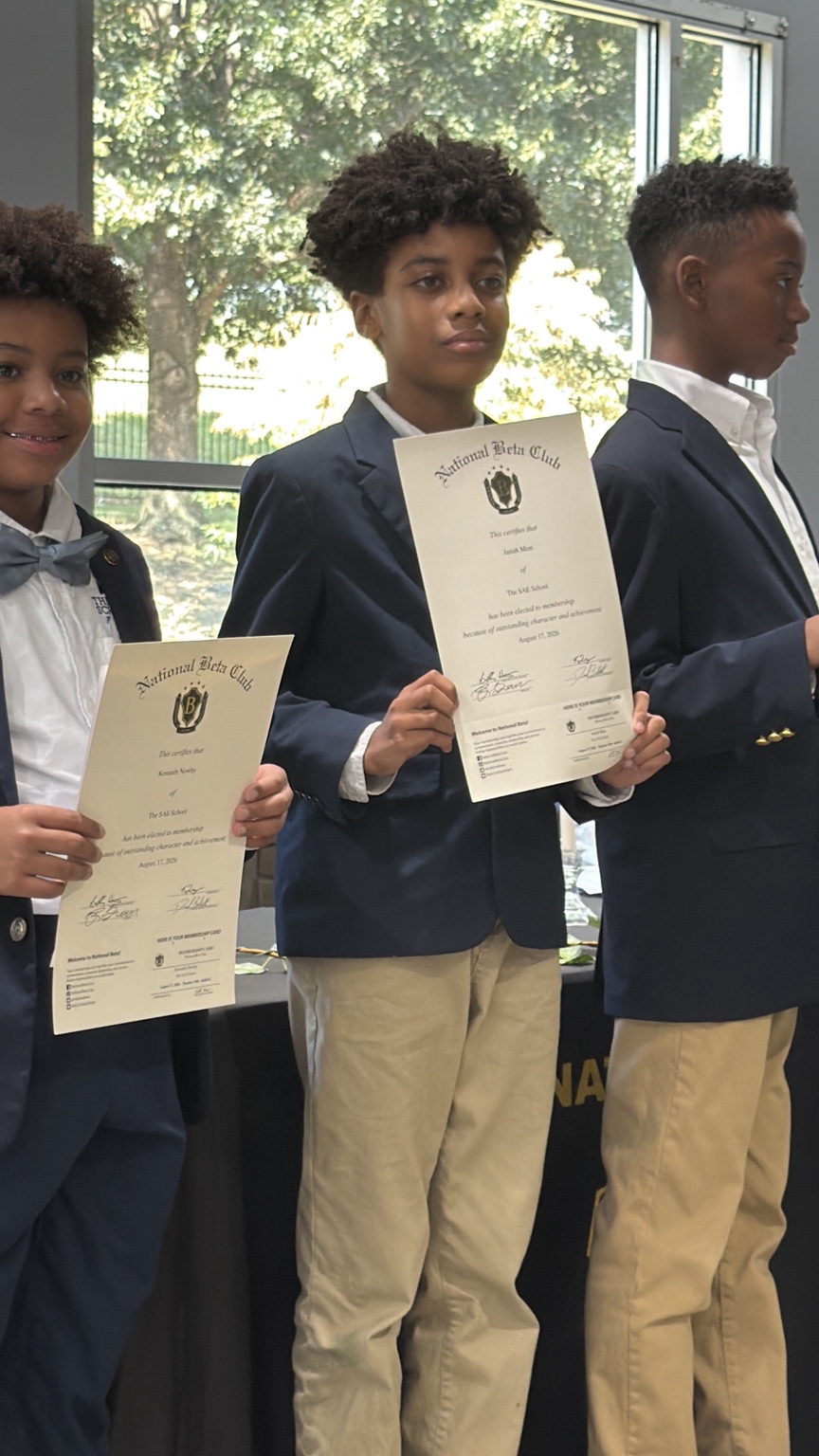 Jasiah Mize holding his National Junior Beta Club certificate